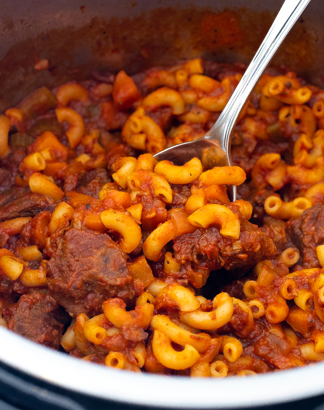 Beefaroni in an instant pot with a silver spoon.