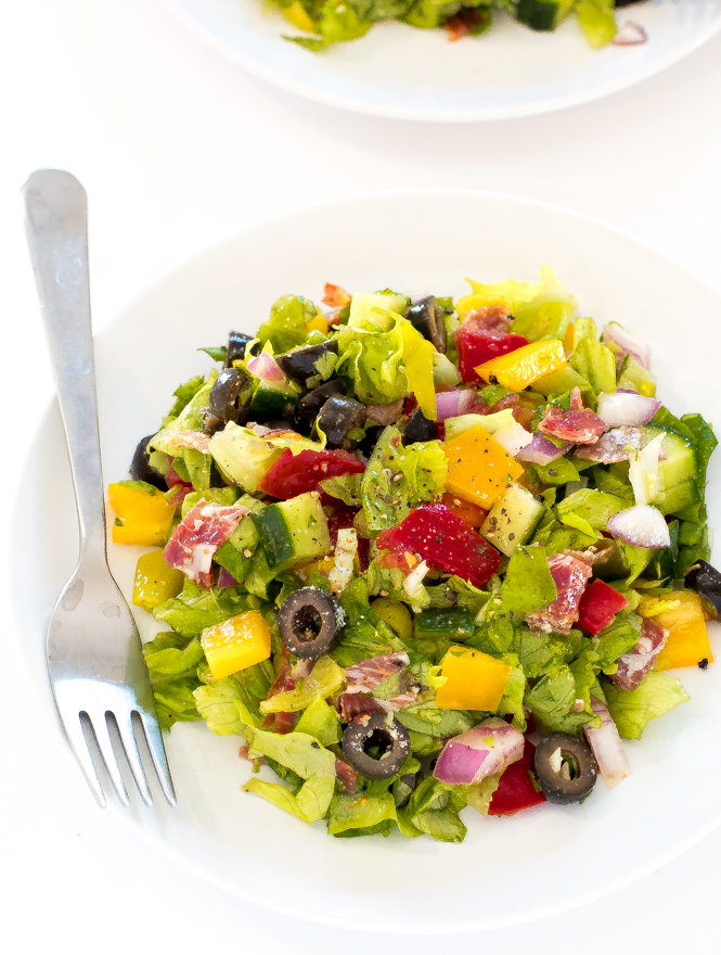 a white plate filled with this colorful homemade Italian chopped salad with a silver fork off to the side | chefsavvy.com
