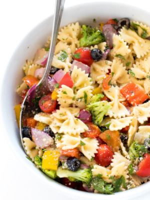 Italian pasta salad in white bowl with spoon