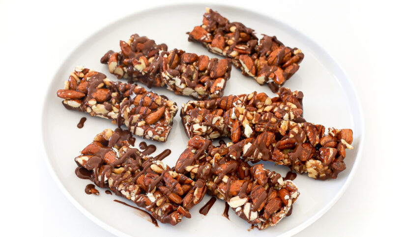 granola bars on white plate drizzled with melted chocolate and salt