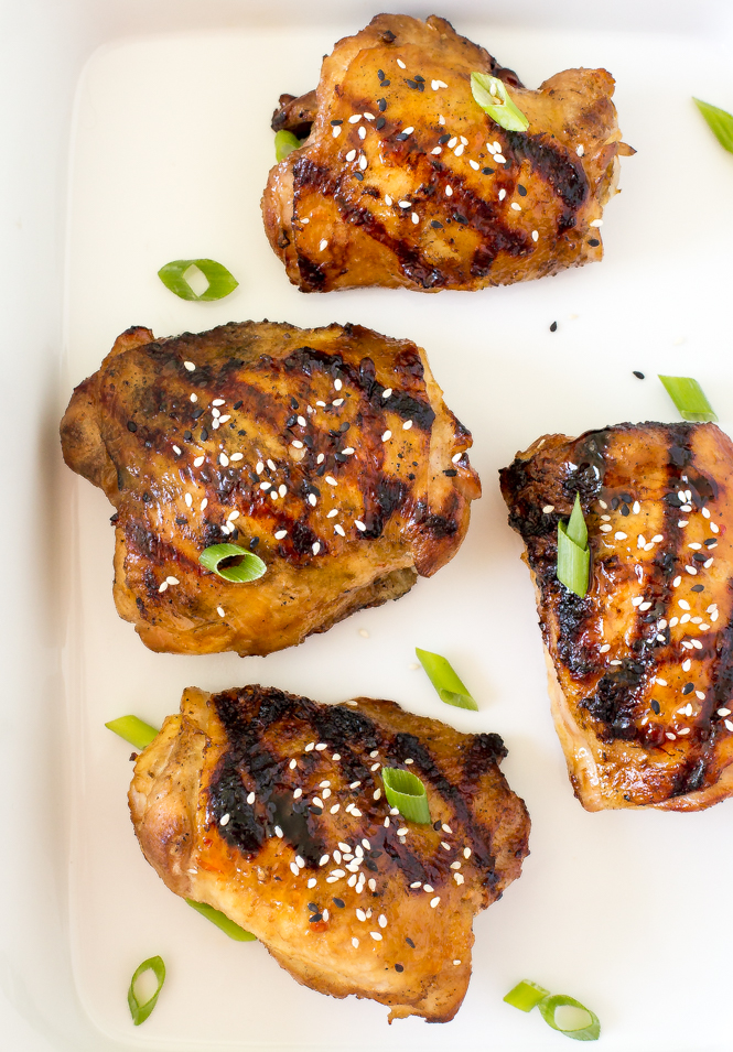 Grilled Korean chicken thighs on white serving tray