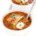 top shot of lasagna soup in white bowl with spoon