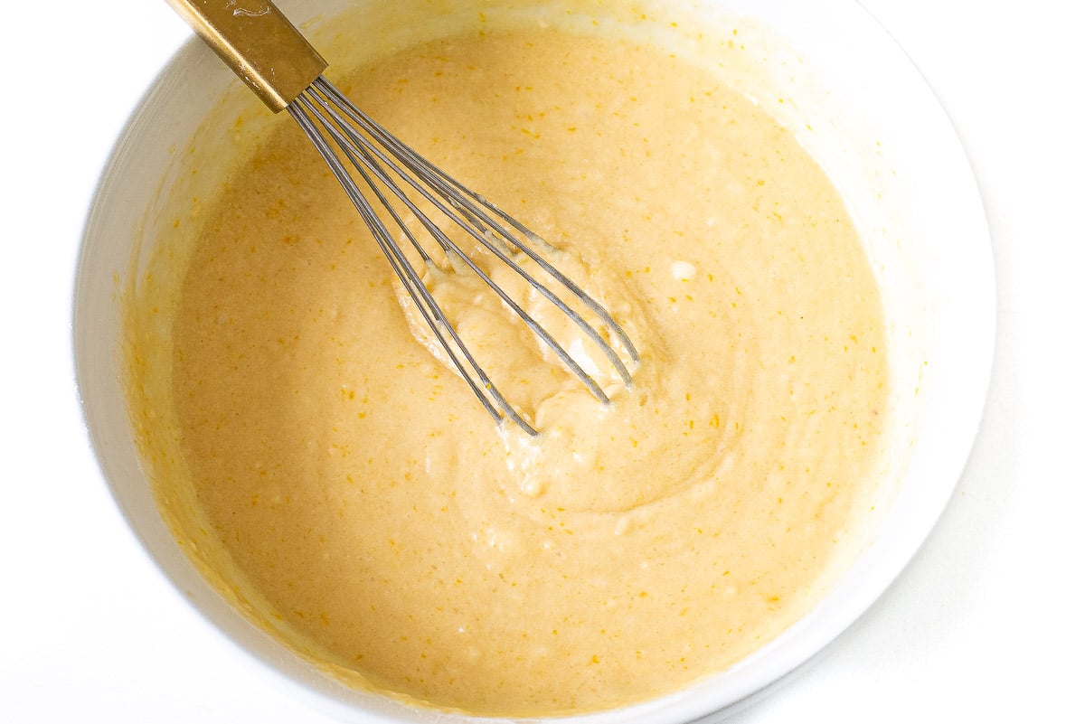 thick lemon loaf batter whisked in white bowl