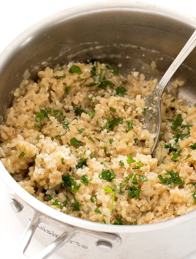 fluffing rice in silver saucepan
