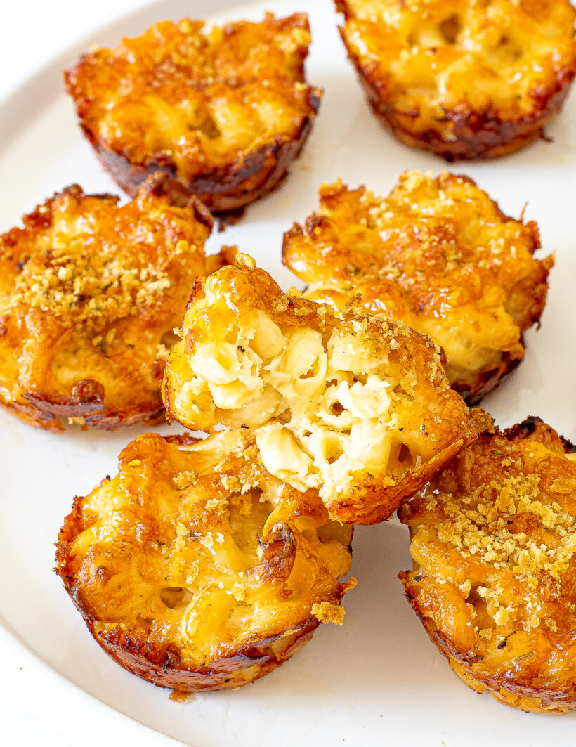 A mac and cheese cup with a bite taken out of it.