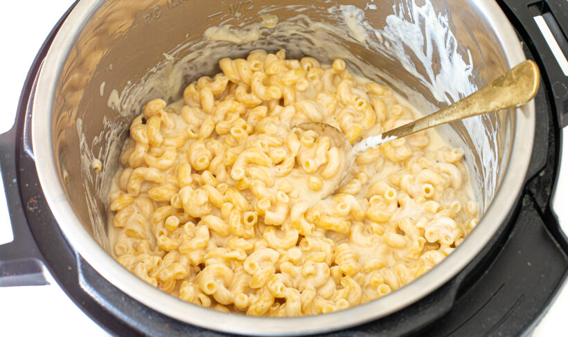 Mac and cheese with a spoon in instant pot.