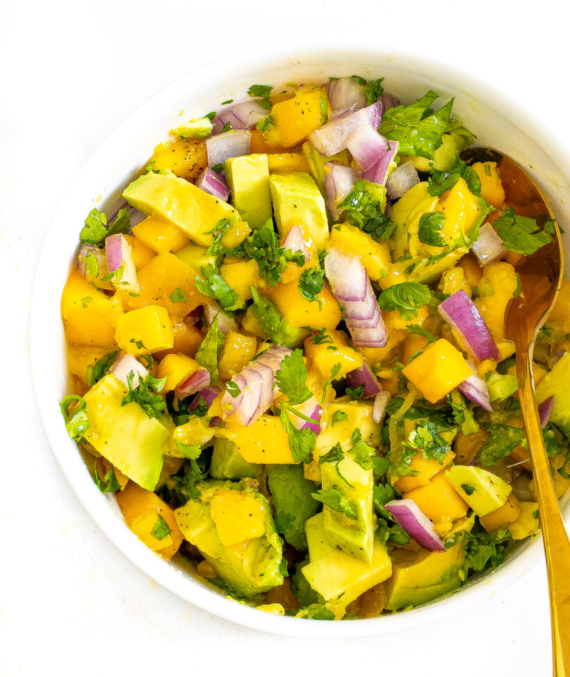 Bowl of mango avocado salsa topped with cilantro.