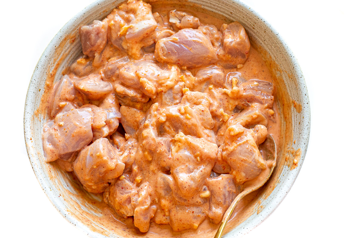 chicken satay ingredients marinating in bowl
