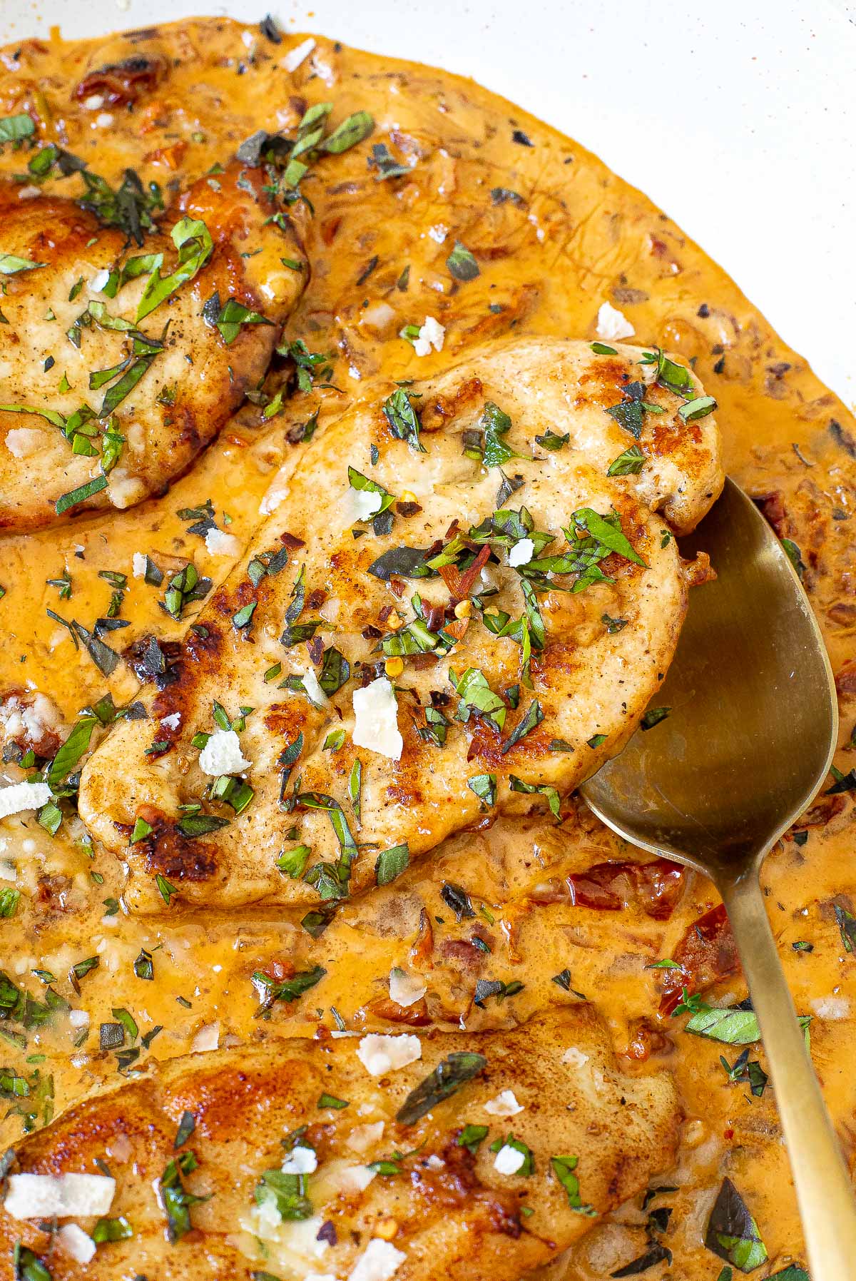 marry me chicken in skillet topped with parmesan cheese and fresh herbs
