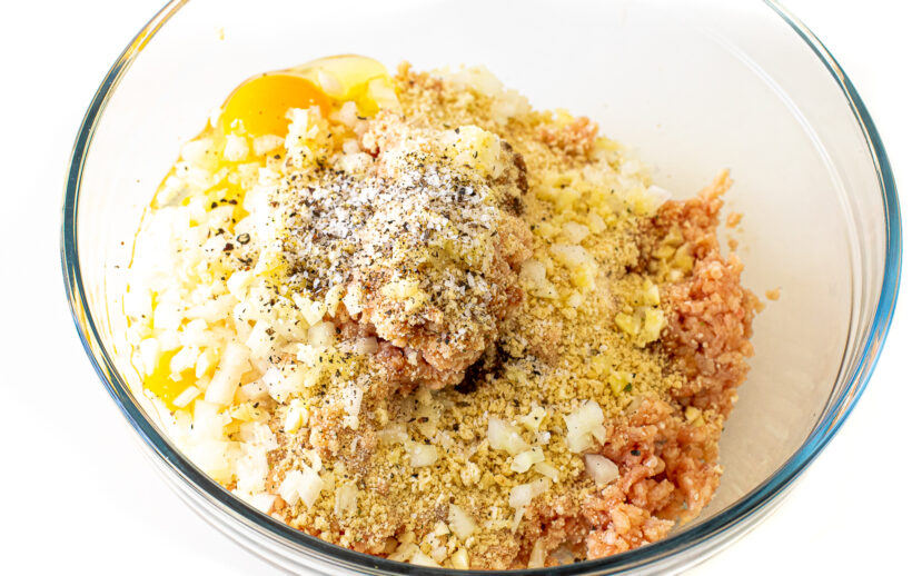 Firecracker meatballs ingredients in a mixing bowl.