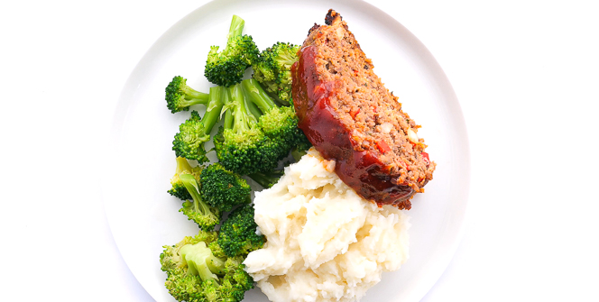 overhead shot of meatloaf, veggies and potatoes on a white plate