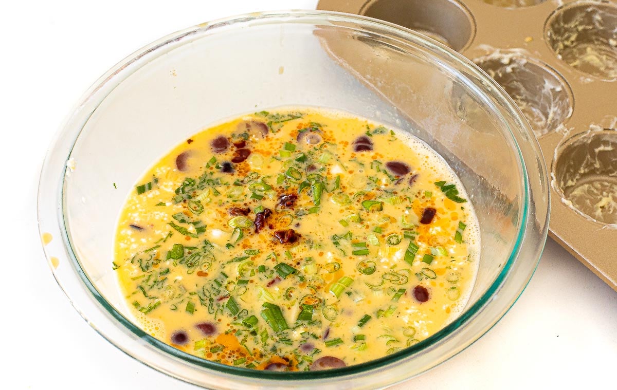 whisking eggs, sun dried tomatoes and herbs