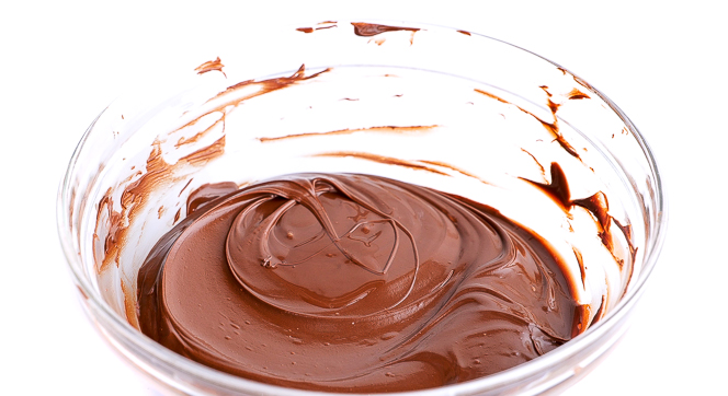 melted semi sweet chocolate and coconut oil in large clear bowl