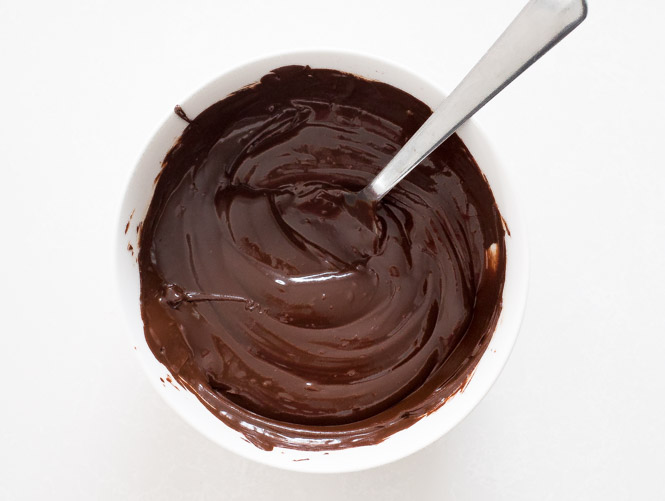 melted dark chocolate in small white bowl