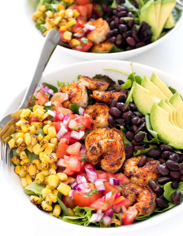 salad topped with corn, pico de Gallo, blackened shrimp, black beans and avocado