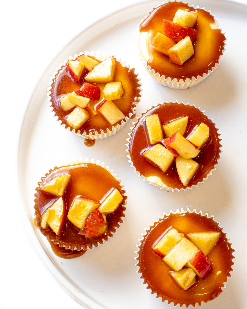 Caramel Apple Mini Cheesecakes placed on a white plate.
