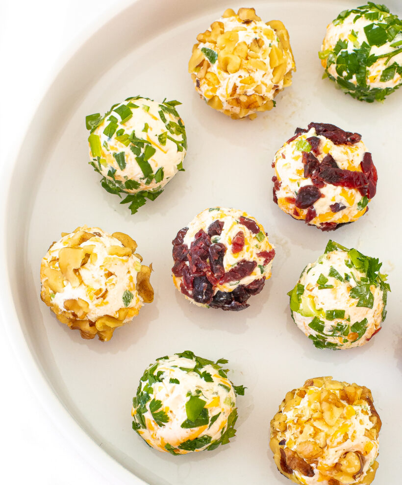 Mini cheese balls placed on a white plate.