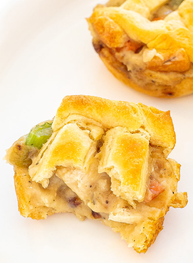 Close up shot of mini chicken pot pie with a bite taken out of it. 