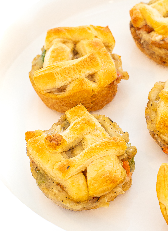 Close up shot of mini chicken pot pies on a white plate. 