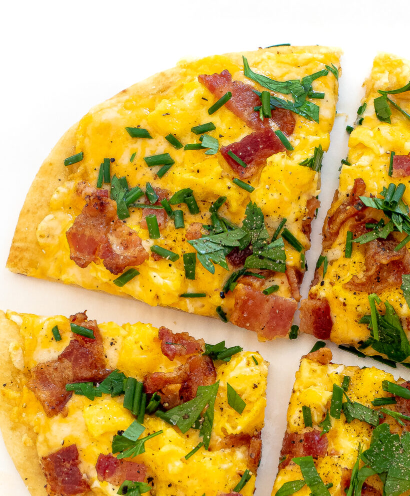 Up close shot of a slice of breakfast pizza pita. 