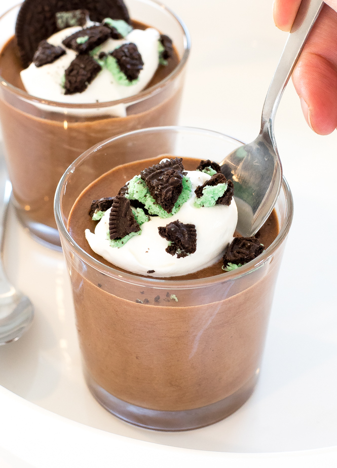 Mint Chocolate Mousse in glass cups with peppermint whipped cream and chopped mint oreos 