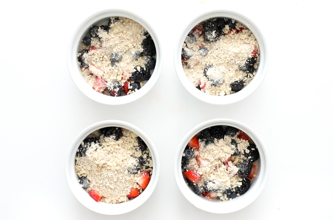 Mixed berries in white ramekins with crisp topping Mixed berries in white ramekins with crisp topping