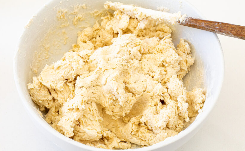 Blueberry bagel dough in a white mixing bowl.