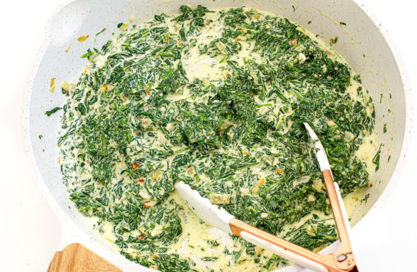 Creamed spinach in a skillet after being cooked together. 