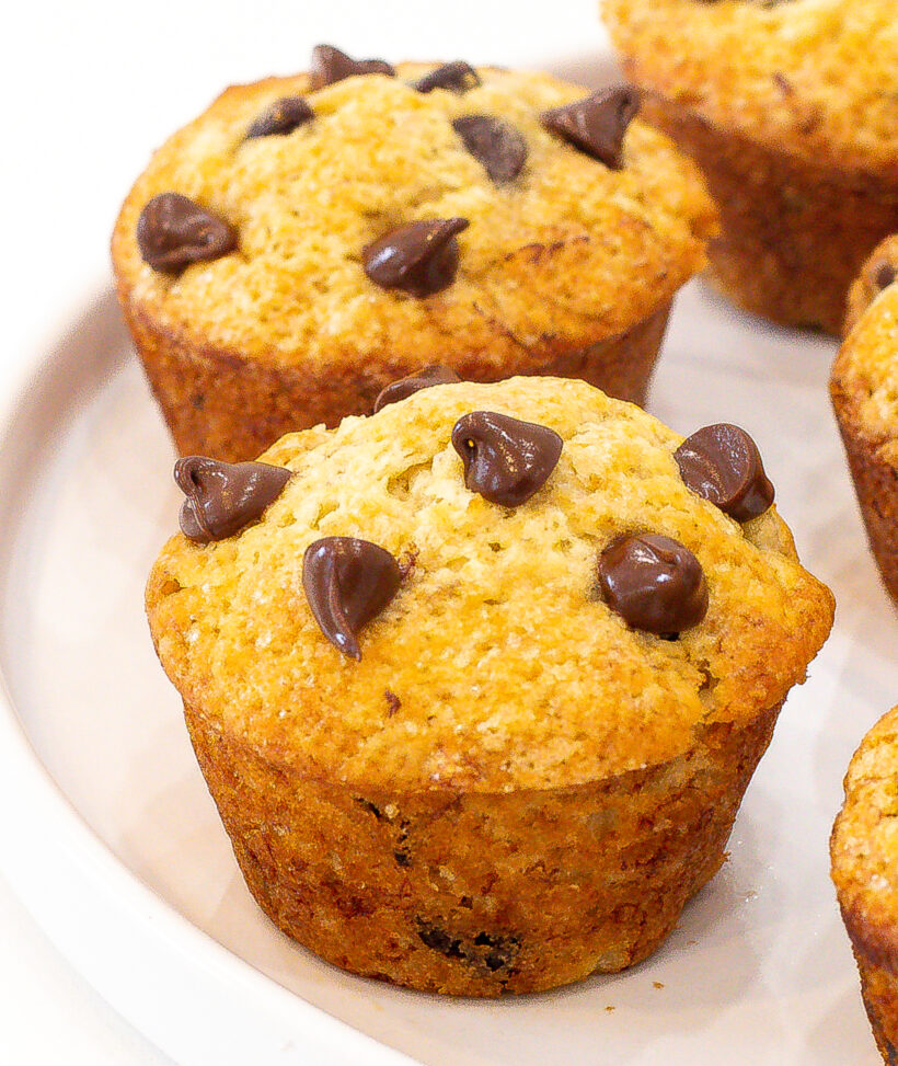 Close up shot of a banana muffin with chocolate chips on top.