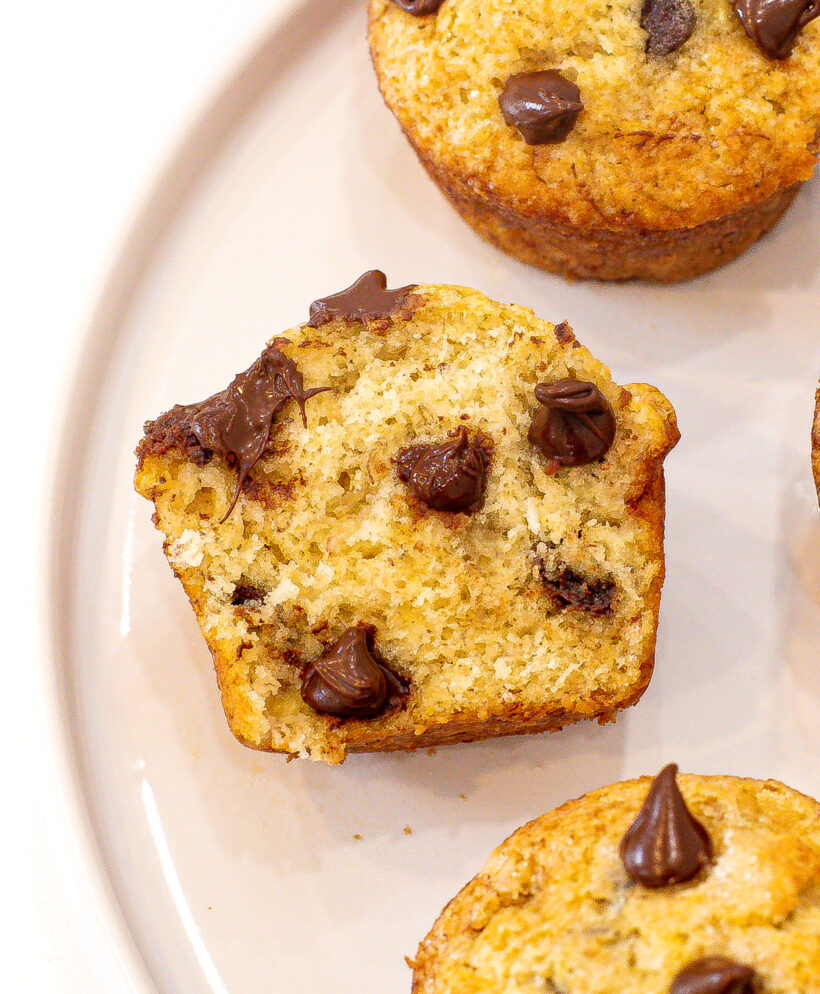 Banana chocolate chip muffin cut in half and viewed from the side.