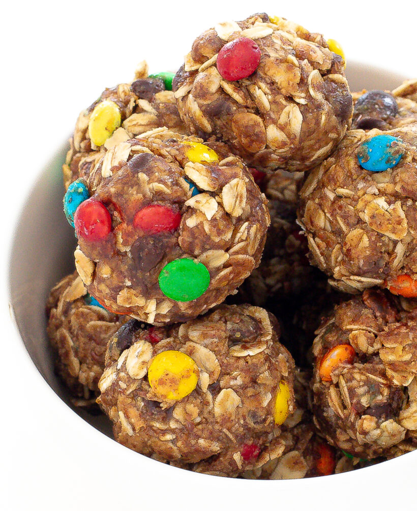 Monster energy balls stacked on top of each other in a white bowl.