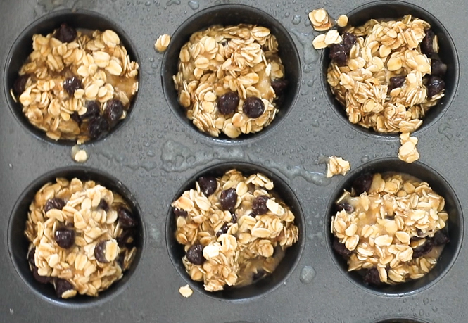 scooping banana oatmeal muffins into muffin tin.