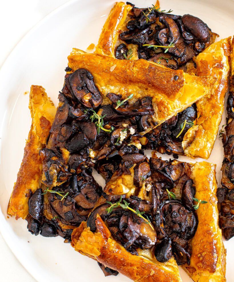 Overhead shot of mushroom tart sliced into triangles. 