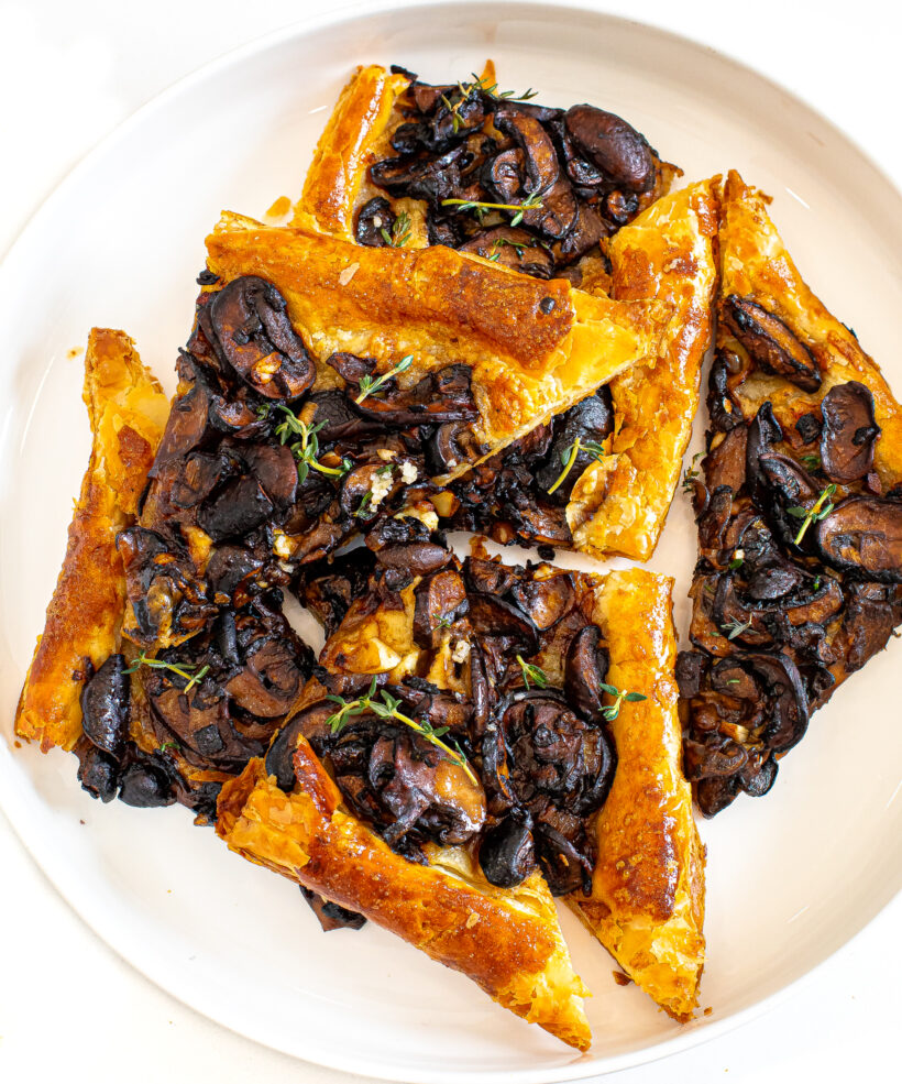 Slices of a mushroom tart on a serving plate. 