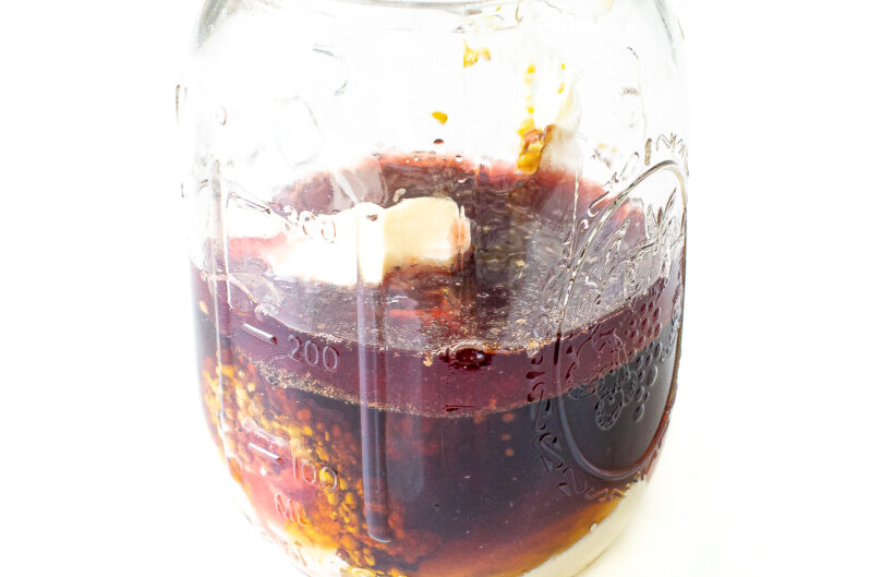 Honey mustard dressing ingredients in a Mason jar.