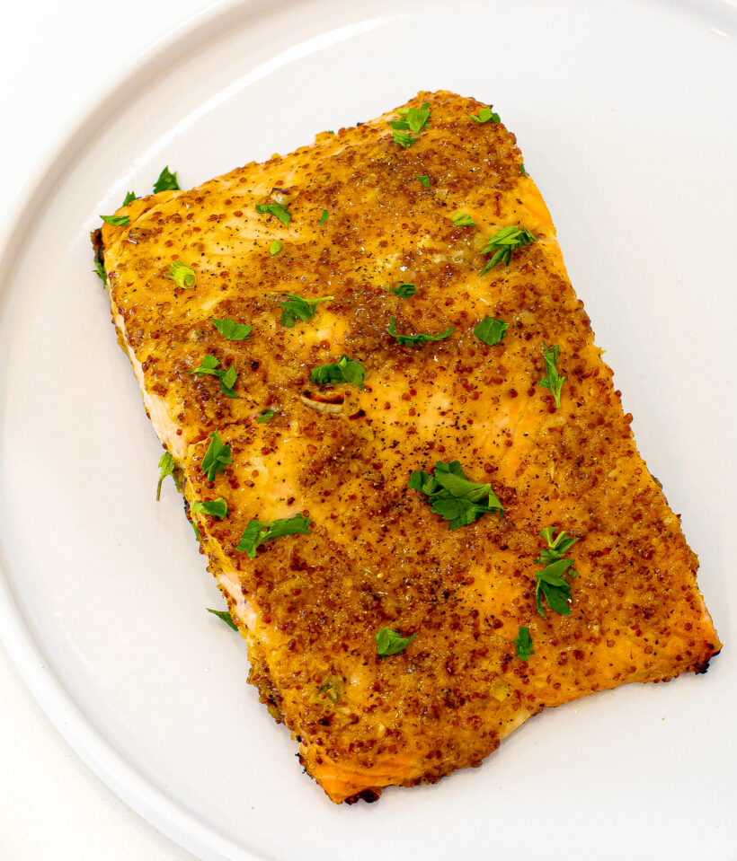 Honey mustard salmon filet served on a white plate. 