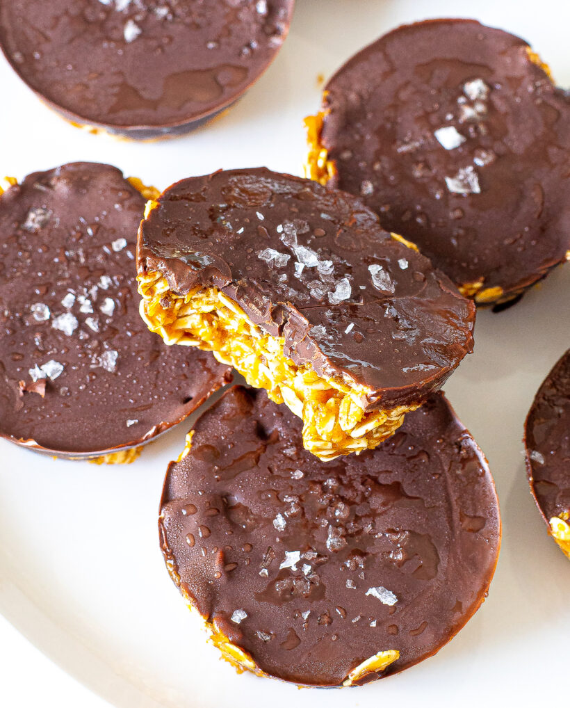 A no bake pumpkin oat cup with a bite taken out of it.