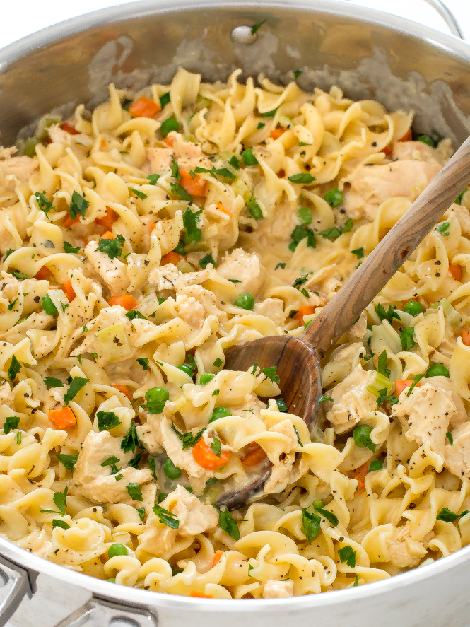 chicken pot pie pasta in large skillet topped with fresh parsley
