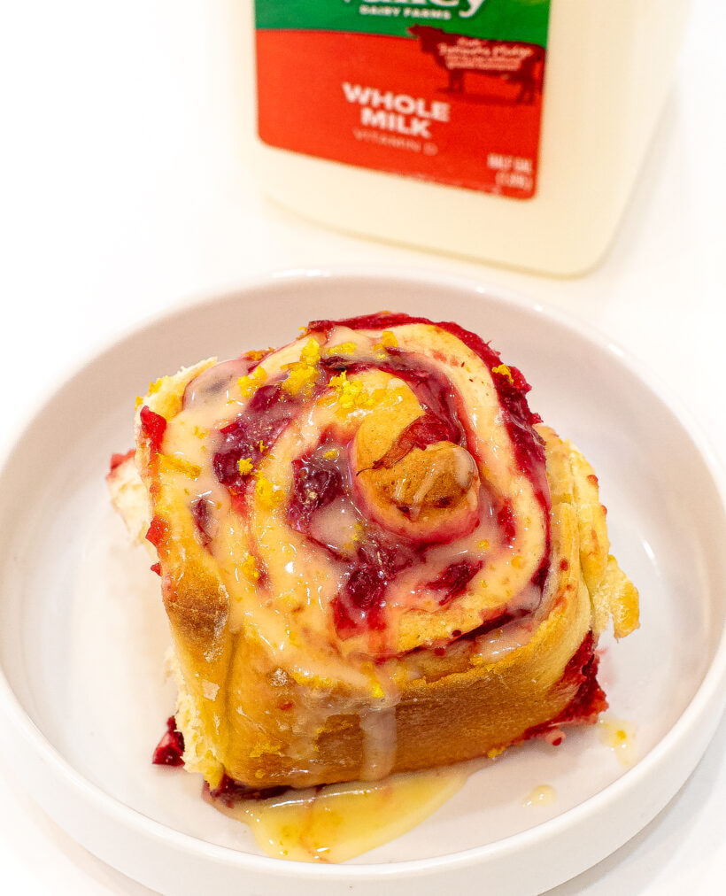 Orange cranberry roll in a white dish.