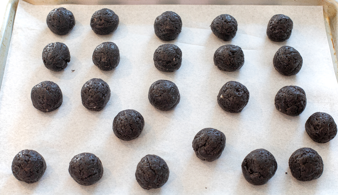 Oreo balls on baking sheet lined with parchment paper