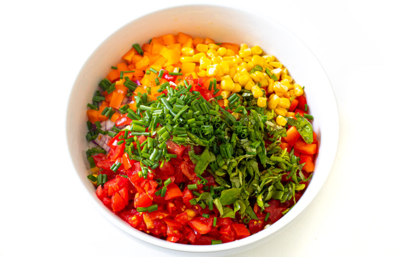 Vegetables diced and placed in a mixing bowl. 