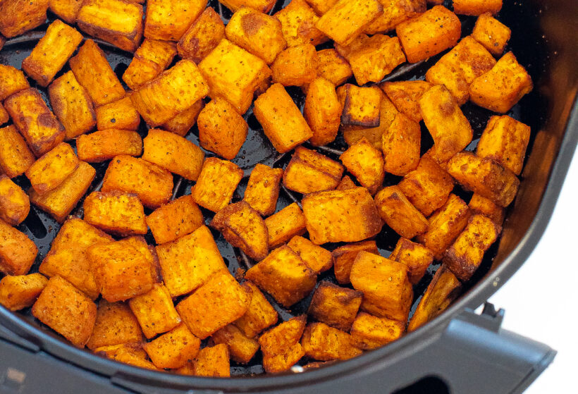 Sweet potatoes being cooked in an air fryer.