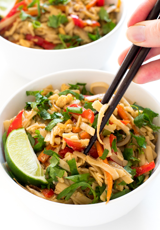 Easy Pad Thai Recipe | chefsavvy.com using chop sticks to scoop up pad Thai out of white bowls.