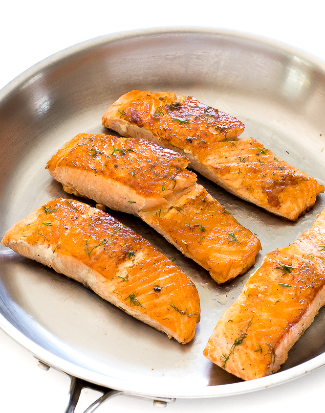 Salmon with Lemon Dill Butter | chefsavvy.com Lemon Dill Salmon in a frying pan.