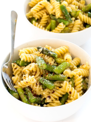 close up of this Lemon Asparagus Pasta in white bowls with a fork | chefsavvy.com