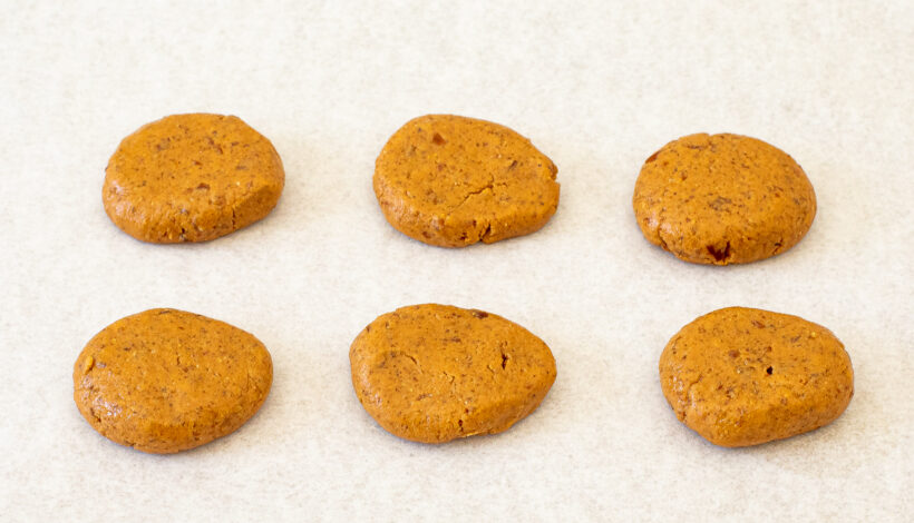 Peanut Butter eggs laid out on a parchment paper lined baking sheet.