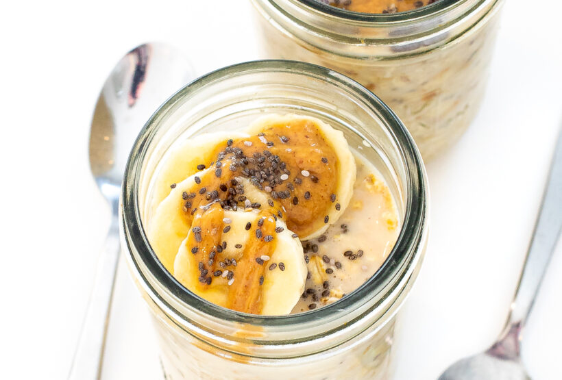 Overhead shot of oats in a jar with bananas on top.