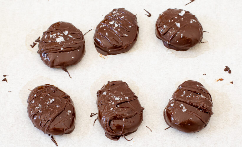Peanut butter eggs coated in chocolate and sprinkled with sea salt.