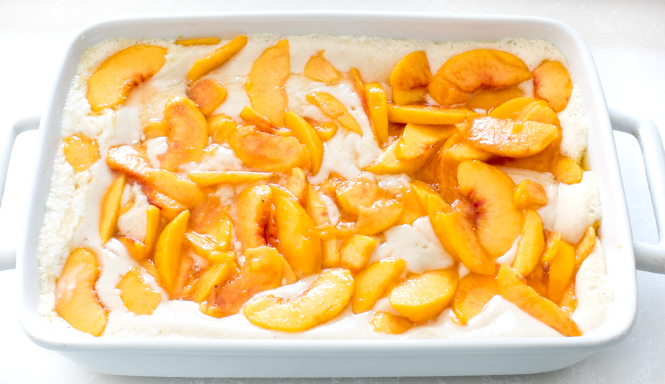 adding peaches to the top of unbaked cobbler