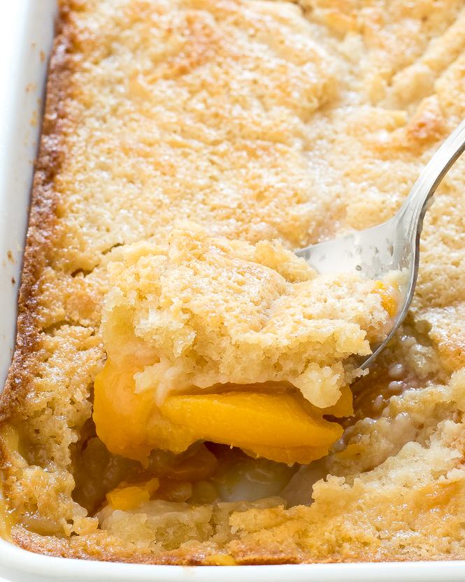 Homemade Peach Cobbler in white casserole dish